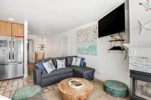 a living room with a couch and a table at Sand Castle Villa in Rockaway Beach