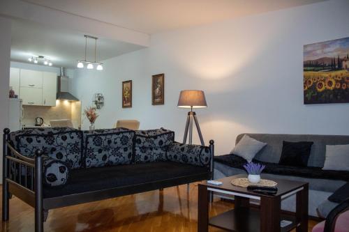 a living room with a couch and a table at Apartman Petar Pan in Grude