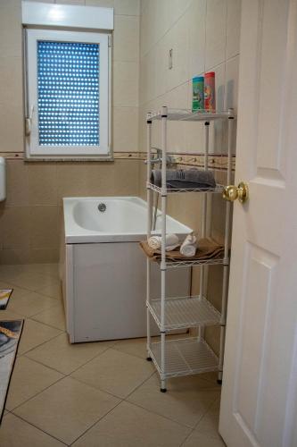 a bathroom with a bath tub and a sink at Apartman Petar Pan in Grude