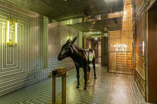a statue of a horse standing in a hallway at Casa Gracia in Barcelona