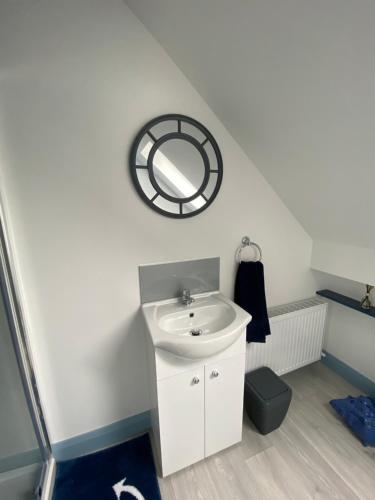 a bathroom with a sink and a mirror on the wall at Blue Pearl Apartment in Downings