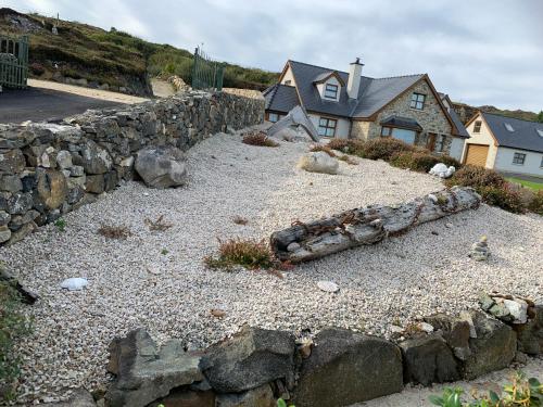 a stone retaining wall in front of a house at Blue Pearl Apartment in Downings