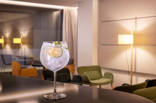 a drink in a glass sitting on a table at Eurostars Pórtico Alicante in Alicante