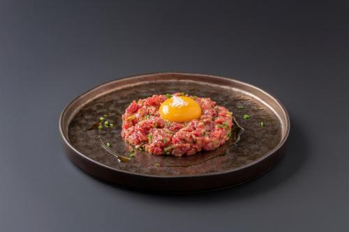 a fried egg on a plate on a table at Eurostars Pórtico Alicante in Alicante