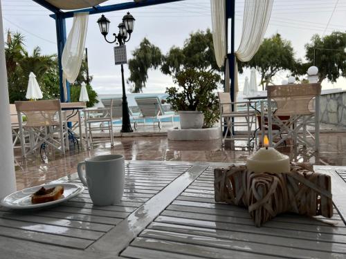 a table with a cup of coffee and a plate of food at Villa Ilios in Fira