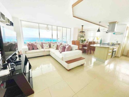 a living room with a white couch and a table at 3 Bedrooms At Marbella Beachfront Juan Dolio in Juan Dolio
