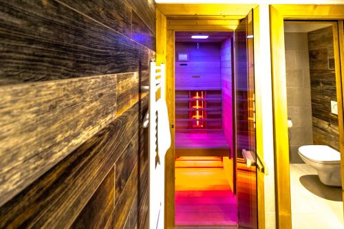 a bathroom with a purple and purple stairway at Cardinal Jasna Mountain Wellness Apartment in Demanovska Dolina