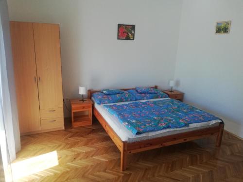 a small bedroom with a bed and a cabinet at Total Relax Apartmanház in Bogács