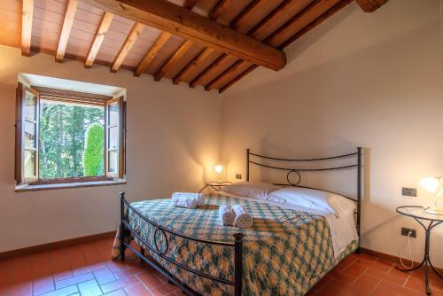 a bedroom with a bed and a window at Live Tuscany! Apartment on the hills of Florence! in Ginestra
