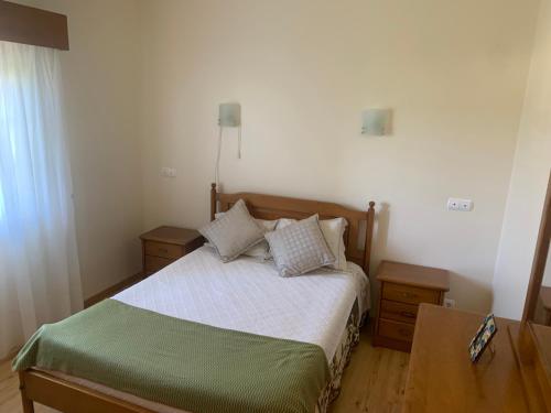 a small bedroom with a bed and two night stands at Santa Barbara Healthcare & Villas in Santa Barbara
