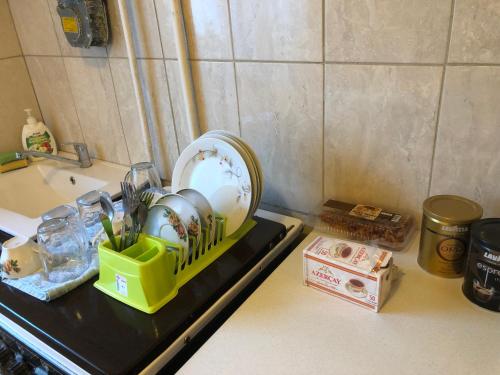 a kitchen counter with a plate and dishes on it at kvartira in Krāslava