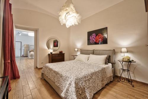 a bedroom with a bed and a chandelier at Casa LENA by Apartments To Art in Turin