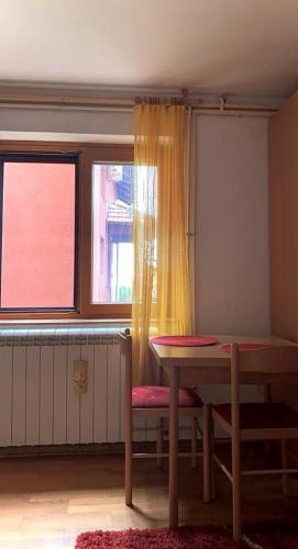 a dining room with a table and a window at Taras House in Zvezdara