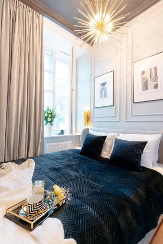 a bedroom with a large bed with a tray on it at Warsaw Story - LoftAffair Collection in Warsaw