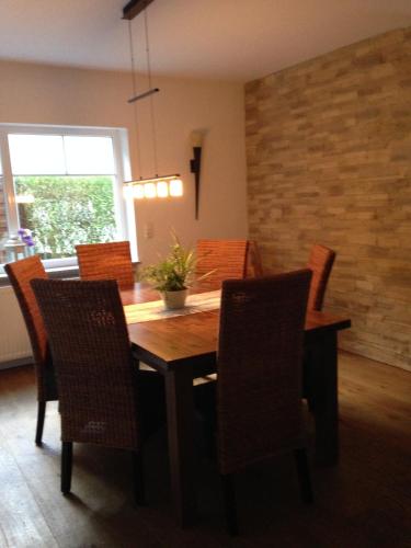 a dining room with a wooden table and chairs at Ferienwohnung Magma in Lutzerath