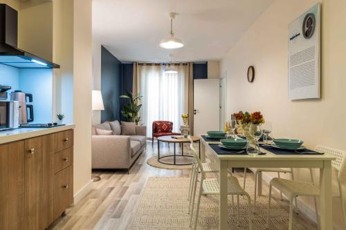a kitchen and a living room with a table and chairs at Monnas Suite in Istanbul