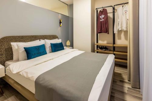 a bedroom with a large bed with blue pillows at Monnas Suite in Istanbul