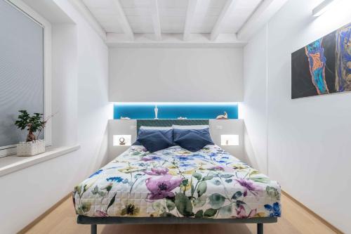 a bedroom with a bed with a floral comforter at Le Dimore in Ortona