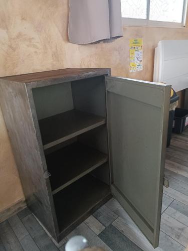 a wooden cabinet with shelves in a room at Dormir à l'usine Loft industriel Atypique in Saint-Quentin-Lamotte-Croix-au-Bailly