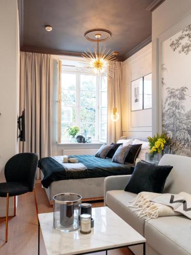 a living room with a bed and a couch at Warsaw Story - LoftAffair Collection in Warsaw