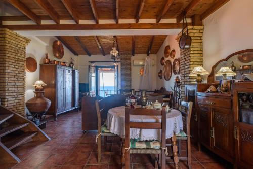a kitchen with a table and a dining room at Eros Pittoresque Retreats - Perfect location, Panoramic Seaview in Koroni