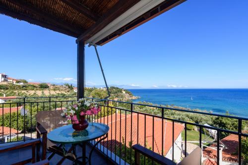 a balcony with a table and a view of the ocean at Eros Pittoresque Retreats - Perfect location, Panoramic Seaview in Koroni