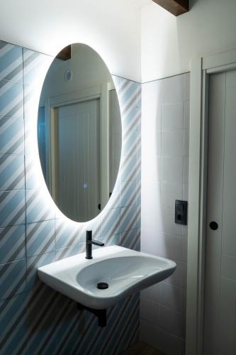 a bathroom with a white sink and a mirror at Casa Rural San Andrés de Teixido in Cedeira