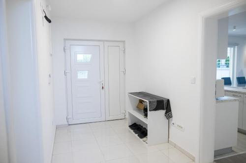 a white room with a door and a microwave at Villa Noor in Sarajevo
