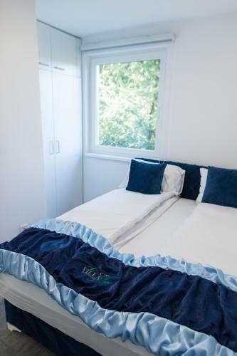 a bed in a room with a window at Villa Noor in Sarajevo