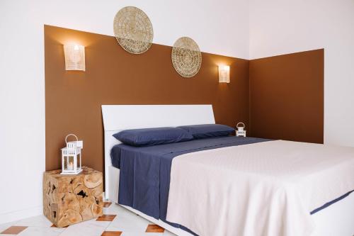 a bedroom with two beds and two mirrors on the wall at Dimore Dalle Zie in Alberobello