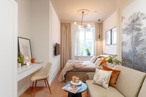 a living room with a bed and a couch at Warsaw Story - LoftAffair Collection in Warsaw