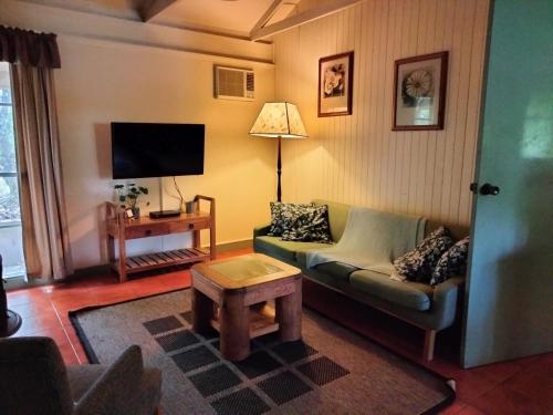 a living room with a couch and a table at Kalimna Woods Cottages in Lakes Entrance