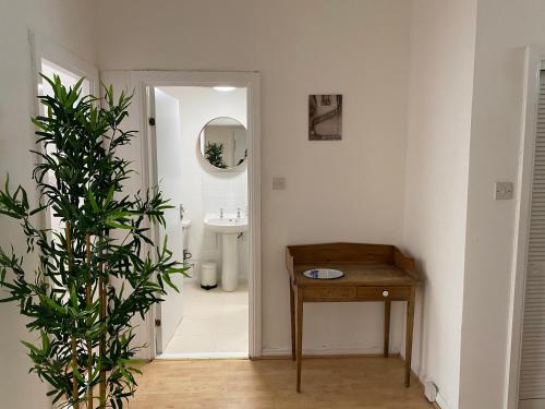 a bathroom with a wooden table and a sink at Lovely 1-Bed Apartment in Glasgow Merchant City in Glasgow