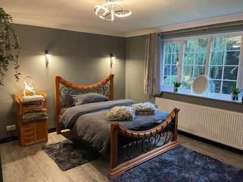 a bedroom with a large bed and a window at Da Vinci Guest House & Guest Parking, A Real Gem in Crawley