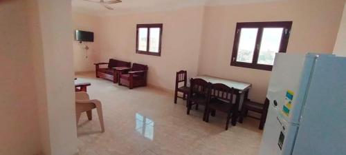 a living room with a couch and a table and chairs at Al Haweej in Marsa Matruh
