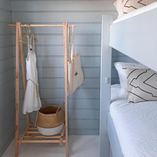 a bedroom with blue walls and a bed and a basket at Casa Pueblo Viejo in Ouddorp