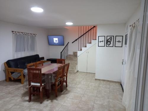 a living room with a table and chairs and a couch at DUPLEX SIRIRIES in Oro Verde