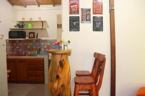 a kitchen with a wooden chair and a counter at Finca la Mariposa, Santa Elena in Santa Elena