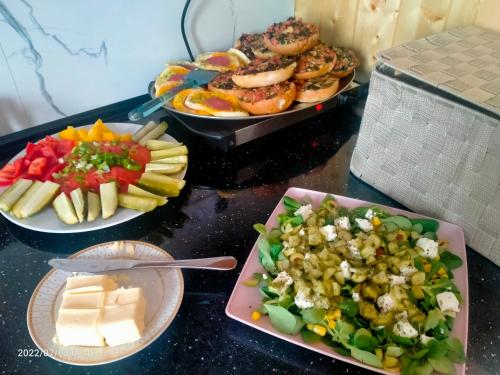 three plates of food on a table with different foods at Noclegi-SKAŁKA in Olsztyn