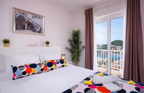 a bedroom with a bed and a large window at Villa Gaga in Dubrovnik