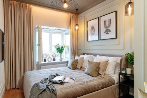 a bedroom with a bed with two books on it at Warsaw Story - LoftAffair Collection in Warsaw