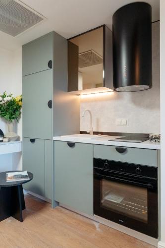 a kitchen with a sink and a stove at Warsaw Story - LoftAffair Collection in Warsaw