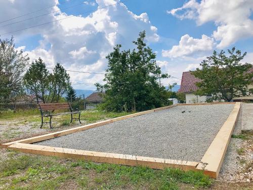 a large slab of gravel next to a bench at Les balcons de Cuttura 1 & SPA chez Ô JurassiK in Cuttura