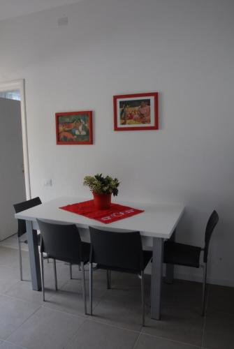 a white table with chairs and a potted plant on it at Da Irene in Mestre