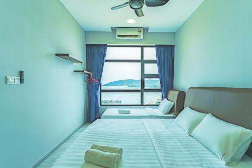 a blue room with a bed with a window at Full Seaview 2R1B Condo for 6pax in Kota Kinabalu in Kota Kinabalu