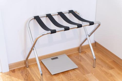 a black and chrome chair with a laptop on the floor at President Apartman 7 in Vračar (historical)