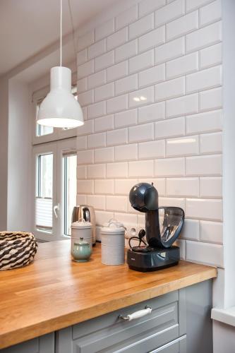 a kitchen counter with a mixer on a wooden counter top at Pokoje Sienkiewicza in Gliwice