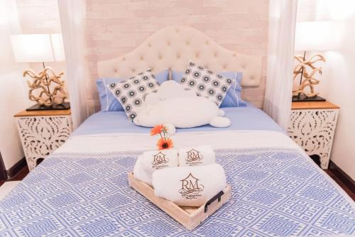 a blue and white bed with two pillows on it at Ruanmata Homestay in Chiang Mai