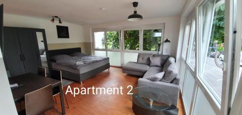 a living room with a couch and a table at SEVIS Outlet Apartments in Metzingen