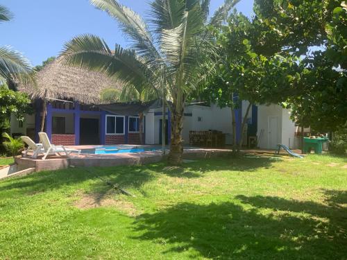 ein Haus mit einer Palme im Hof in der Unterkunft Casa Maria in El Cebollito